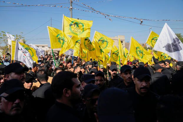 Members from the Popular Mobilization Forces attend the funeral of fighters from Kataib Hezbollah