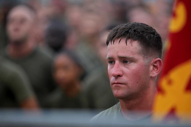 A Marine listens to his regimental commander talks after a regimental run aboard Camp Pendleton, Calif.