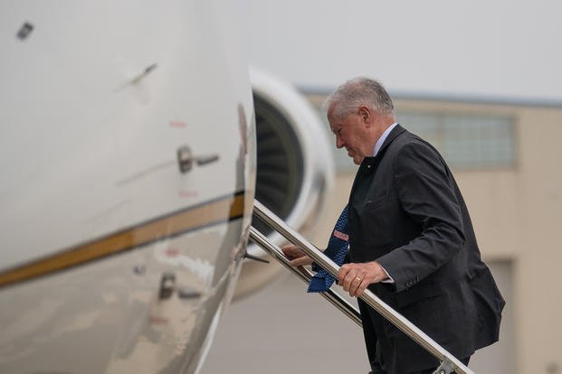 Secretary of the Air Force Frank Kendall ascends stairs to board an aircraft at the 122nd Fighter Wing in Fort Wayne, Indiana. 