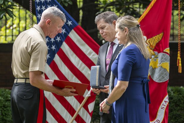 Commandant of the Marine Corps Gen. Eric Smith, with parents of Cpl. Spencer Collart