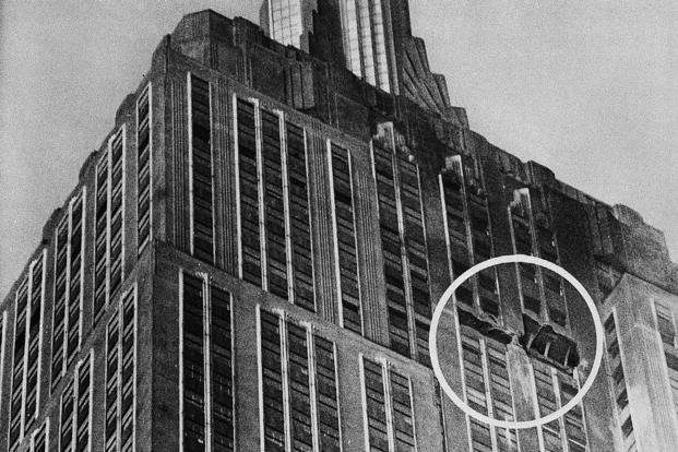 The gaping hole, circled, at the 78th and 79th floors of the Empire State Building in New York marks the place where a B-25 Army bomber crashed into the structure on July 28, 1945, killing 14 people. The photo was taken on July 29 after the dense fog that caused the crash dissipated. 