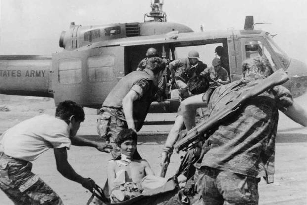 U.S. Army soldiers carrying a man on a stretcher during Vietnam War