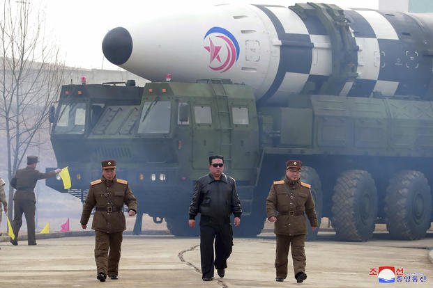 North Korean leader Kim Jong Un walks near what it says is a Hwasong-17 intercontinental ballistic missile