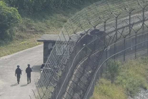 South Korean army soldiers patrol along the barbed-wire fence in Paju, South Korea