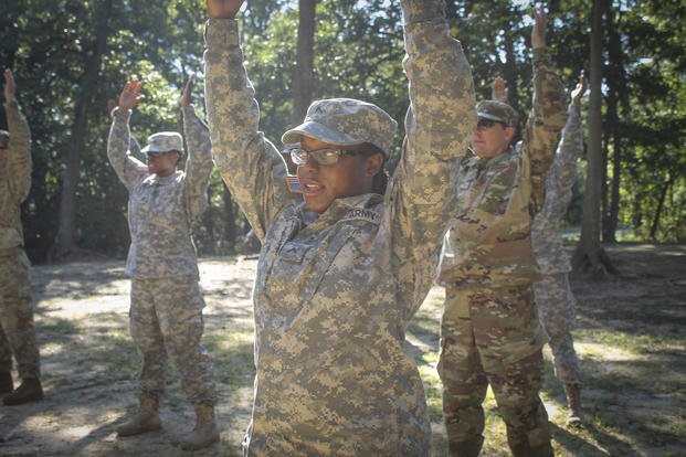 Army Reserve Pfc. Akjla Webb stretches before going out onto an obstacle course on Joint Base McGuire-Dix-Lakehurst.