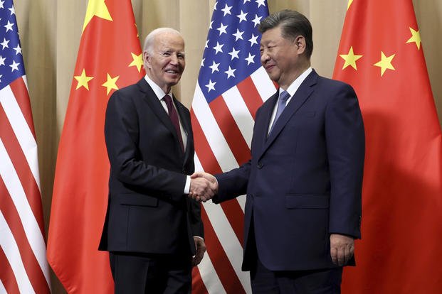 President Joe Biden shakes hands with Chinese President Xi Jinping