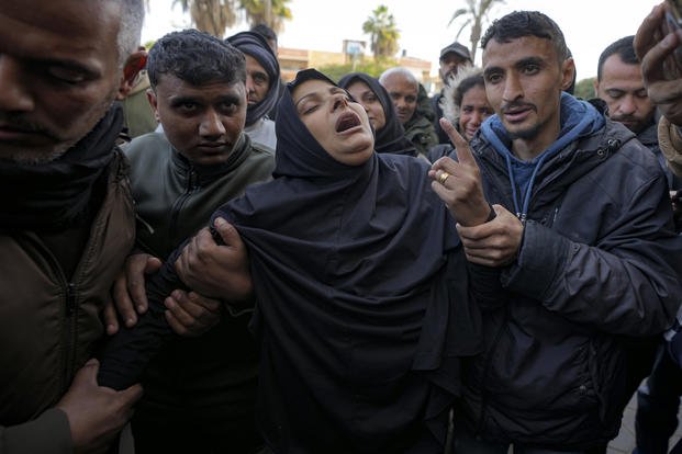 A woman reacts during the funeral of five Palestinian journalists who were killed by an Israeli airstrike