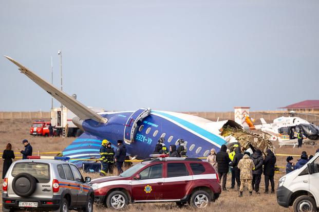 Emergency specialists work at the crash site of an Azerbaijan Airlines passenger jet. 