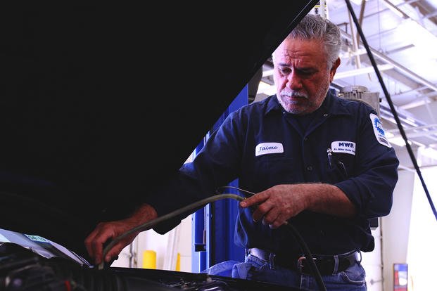 Automotive technician Jaime Garcia performs routine engine maintenance on a customer’s vehicle at Fort Bliss, Texas.