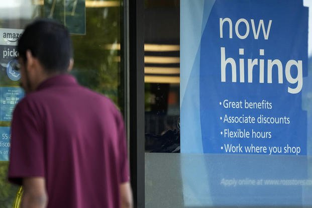 A hiring sign is displayed at a retail store in Schaumburg, Ill.