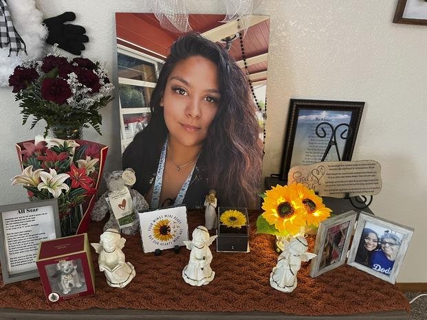 A photograph of Stephanie Cosme sits on an altar