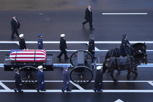 Casket of former President Jimmy Carter travels by a horse-drawn caisson 