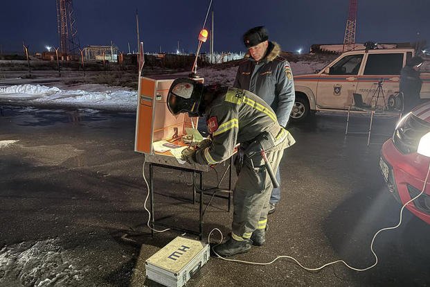 firefighters and rescuers work at the industrial site damaged after Ukrainian drones' attack in Saratov, Russia