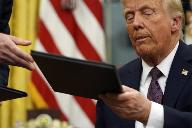 President Donald Trump signs executive orders