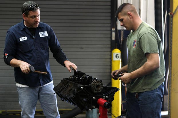 An employee of the Auto Hobby Shop aboard Marine Corps Base Camp Lejeune, N.C., assists a patron. 