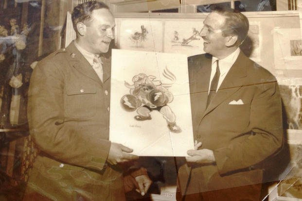 While stationed at Luke Air Force Base in Arizona, Sgt. Seymour Pine had the unique privilege of accepting the 62nd Fighter Squadron emblem of a boxing bulldog from the artist who drew it -- Walt Disney. (Photo courtesy from Richard Pine)