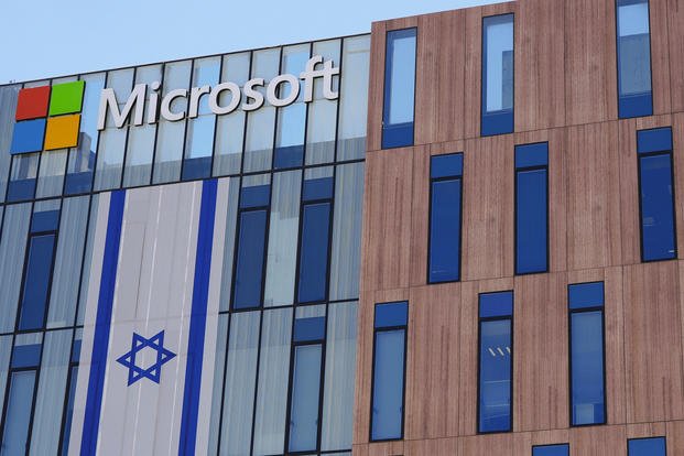 An Israeli flag is draped over the Microsoft offices in a building in the Gav Yam technology park in Beersheba, Israel
