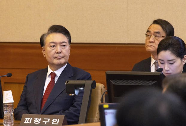 South Korea's impeached President Yoon Suk Yeol, left, attends a hearing of his impeachment trial at the Constitutional Court in Seoul