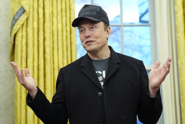 Elon Musk speaks during an event with President Donald Trump in the Oval Office
