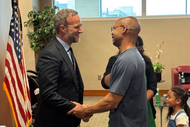 Adam Boehler, the Trump administration's top envoy for hostage affairs greets military contractor Tony Holden