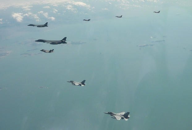 two U.S. Air Force B-1B bomber, top left, fly over the Korean Peninsula