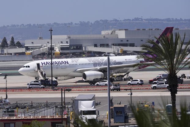 Hawaiian Airlines airplane sits on the tarmac after an evacuation