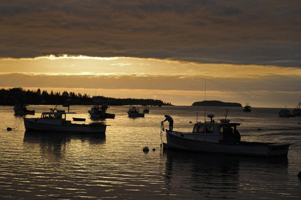 A lobsterman unties his boat before heading out to fish in Jonesport, Maine