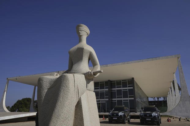 Lady Justice statue, depicting a seated, blindfolded woman holding a sword, stands outside the Supreme Court in Brasilia, Brazil