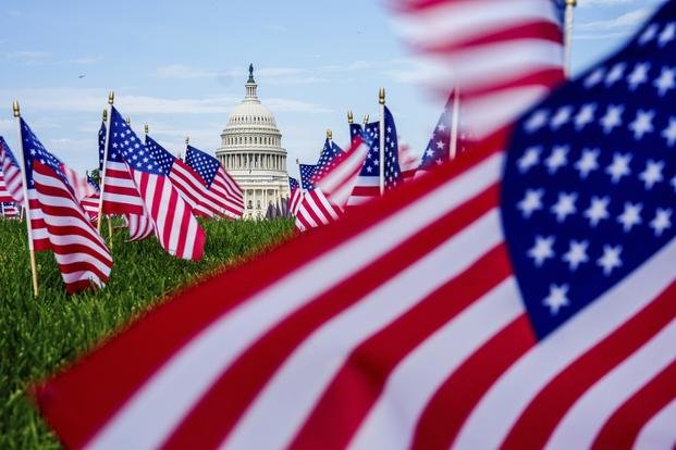 The U.S. Capitol is seen past American flags on the National Mall