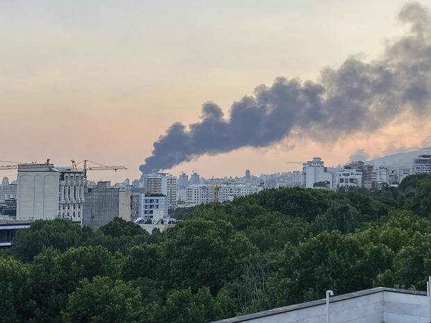 Smoke rises from the building of Iran's state-run television after an Israeli strike in Tehran, Iran.