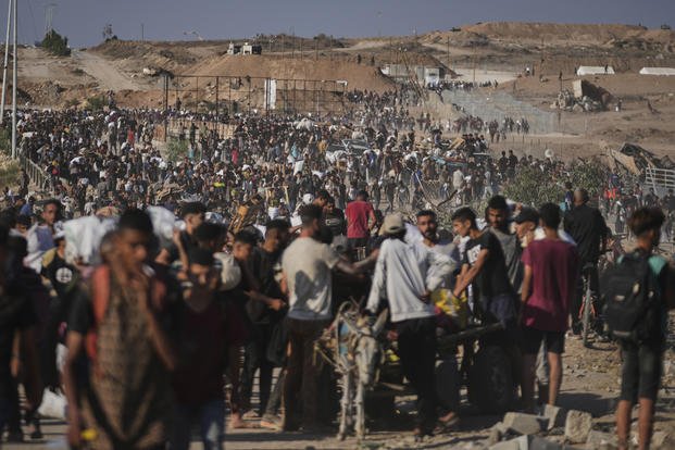 Palestinians carry humanitarian aid packages.