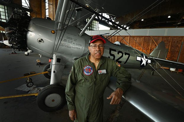 Brian Smith, president and CEO of the Tuskegee Airmen Museum, stands next to a refurbished PT13 at the Coleman A. Young International Airport.