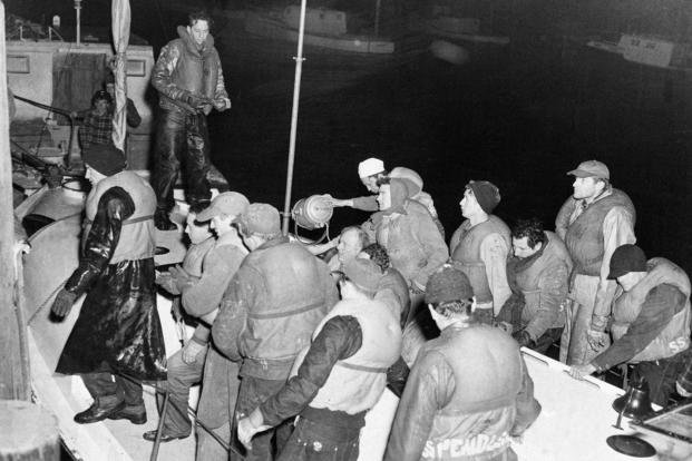 Some of the 32 survivors of the stricken tanker Pendleton that broke up and sank in a northeast storm near Chatham, Mass., Feb. 18, 1952, are pictured as they were rescued by a Coast Guard vessel.