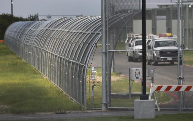 Trucks drive at the Prairieland Detention Center in Alvarado, Texas