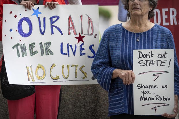Federal workers and supporters rally outside of the State Department
