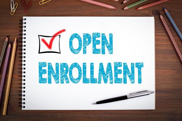 The words open enrollment doodled on a notebook page.