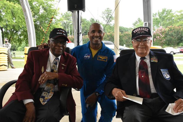 NASA astronaut Victor Glover Jr., center, is flanked by former Tuskegee Airmen Lt. Col. James Harvey, left, and Lt. Col. George Hardy