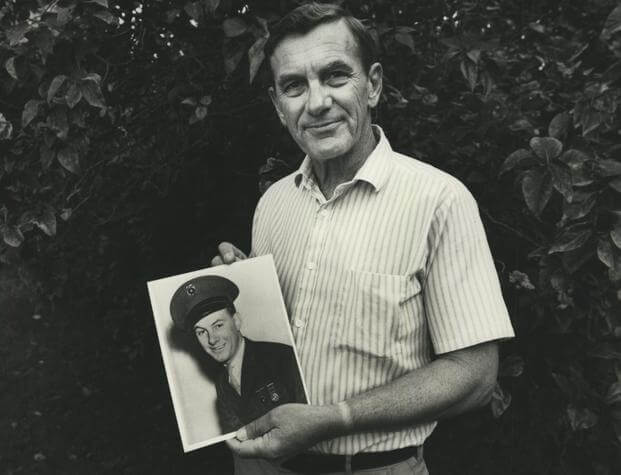Ken Budd holds a photo of brother, Robert in 1989. The photo was taken shortly before Ken's 3rd trip to Guadalcanal to look for his brother's body. Robert was found in 2021, just a month after his brother's death. 