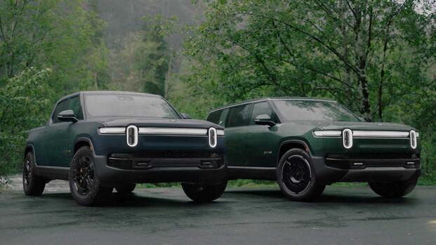 2025 Rivian R1T and R1S Dark Green Front Angle Group Shot