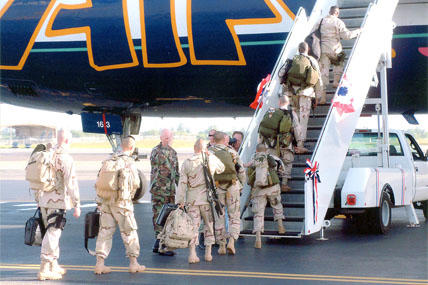 servicemembers boarding jet