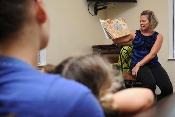 Kelly Wallace, Families OverComing Under Stress resiliency trainer, reads a book during FOCUS story time for preschoolers Aug. 20, 2014, at the Forest City Community Center, Keesler Air Force Base, Miss. (U.S. Air Force photo by Kemberly Groue)