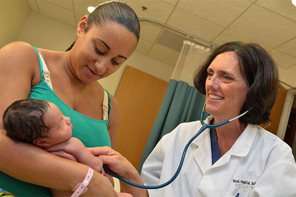 Dr. Julie Kellogg, a physician at Naval Hospital (NH) Jacksonville, checks the heartbeat of Chantel Johnson’s newborn girl, Zamira. (U.S. Navy photo by Jacob Sippel, Naval Hospital Jacksonville Public Affairs/Released)