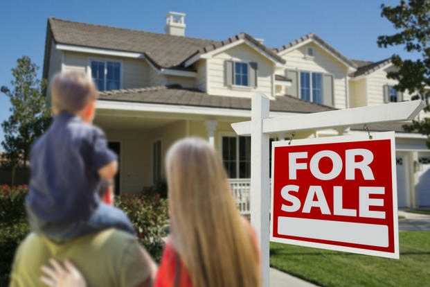 young family looking at a house