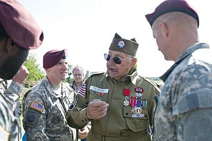 Army paratroopers talk with WWII veterans during D-Day anniversary ceremony