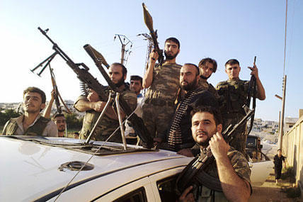 In this citizen journalism image provided by Shaam News Network SNN, taken on Sunday, Aug. 12, 2012, Free Syrian Army soldiers pose for a photograph, in Sarmada, Idlib province, northern Syria. 