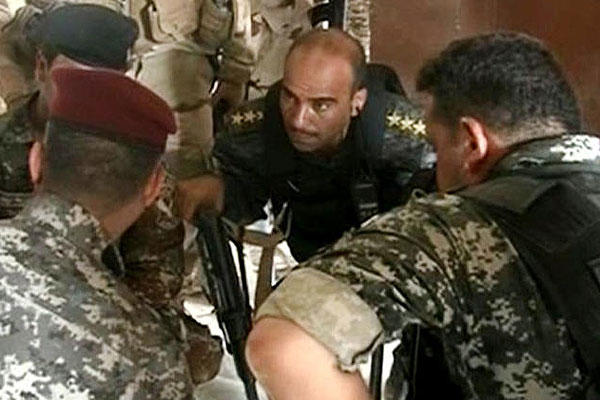 In this, June 9, 2014 image taken from video obtained from the Iraqi Military, which has been authenticated based on its contents and other AP reporting, armed Iraqi military soldiers gather in the northern city of Mosul, Iraq. (AP Photo/Iraqi Military)