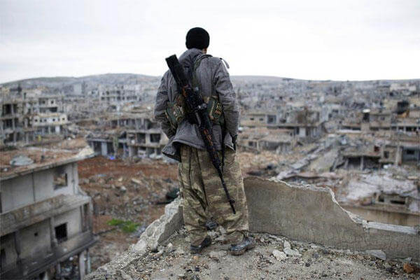 In this Jan. 30, 2015, file photo, a Syrian Kurdish sniper looks at the rubble in the Syrian city of Ain al-Arab, also known as Kobani. (AP Photo, File)