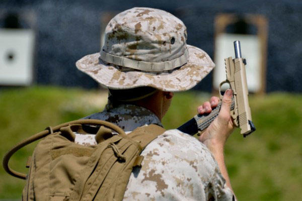 MARSOC operator changes magazines into a M45A1 close quarter battle pistol. (Marine Corps photo)