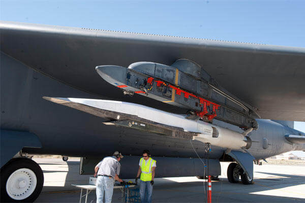 Ground crew members make the final checks to the X-51A Waverider scramjet-powered hypersonic flight demonstrator, which is affixed to an Edwards Air Force Base B-52H Stratofortress. (Photo by Bob Ferguson/Boeing) 