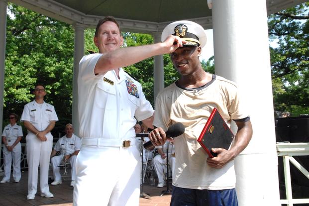 Naval Academy Superintendent, Vice Adm. Walter “Ted” Carter, congratulates Midshipman Fourth Class Javarri Beachum of Port Saint Joe, Fla for capping Herndon Monument. (USNA/Gin Kai)